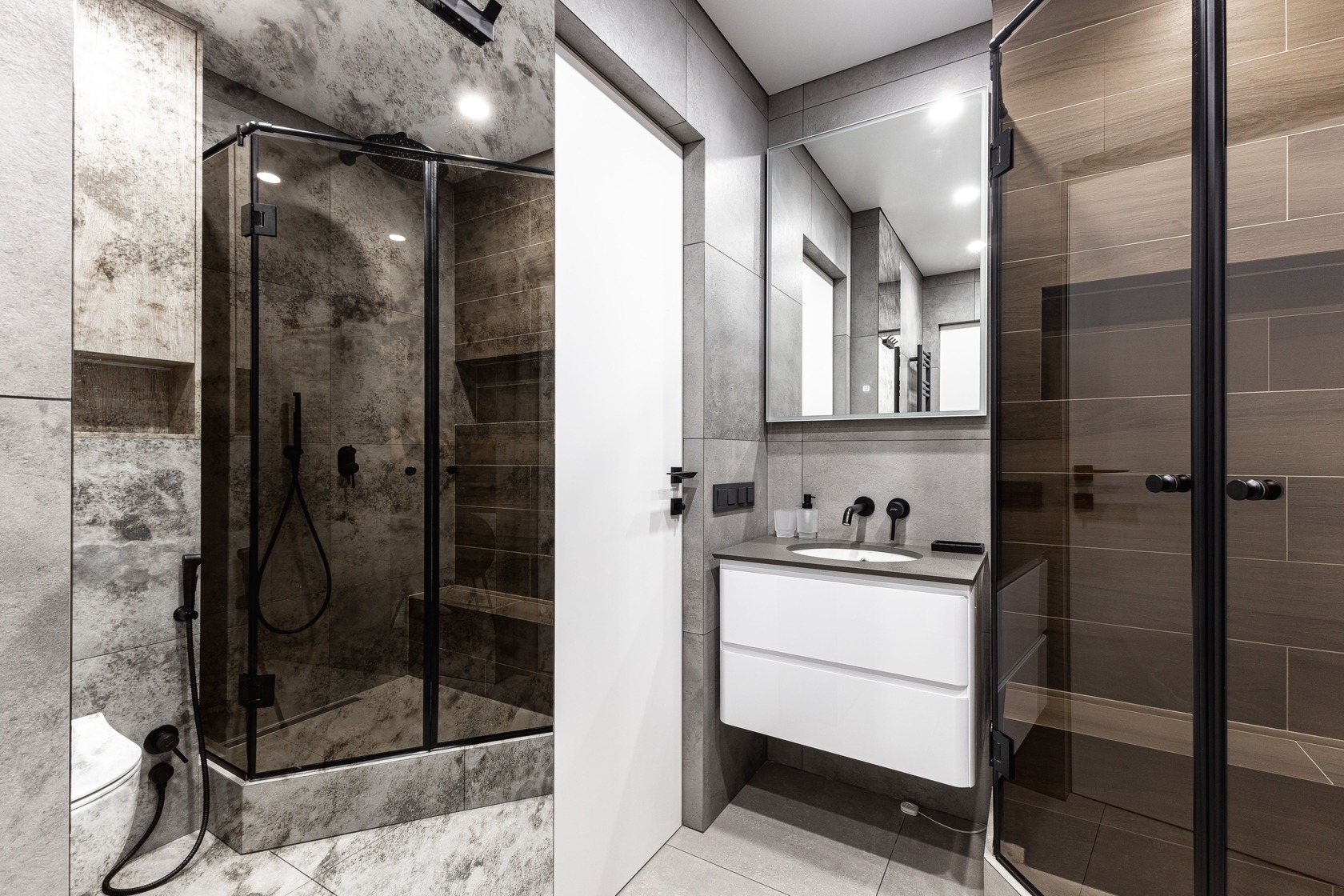 Additional view of the bathroom renovation with glazed shower, stone textures and floating vanity