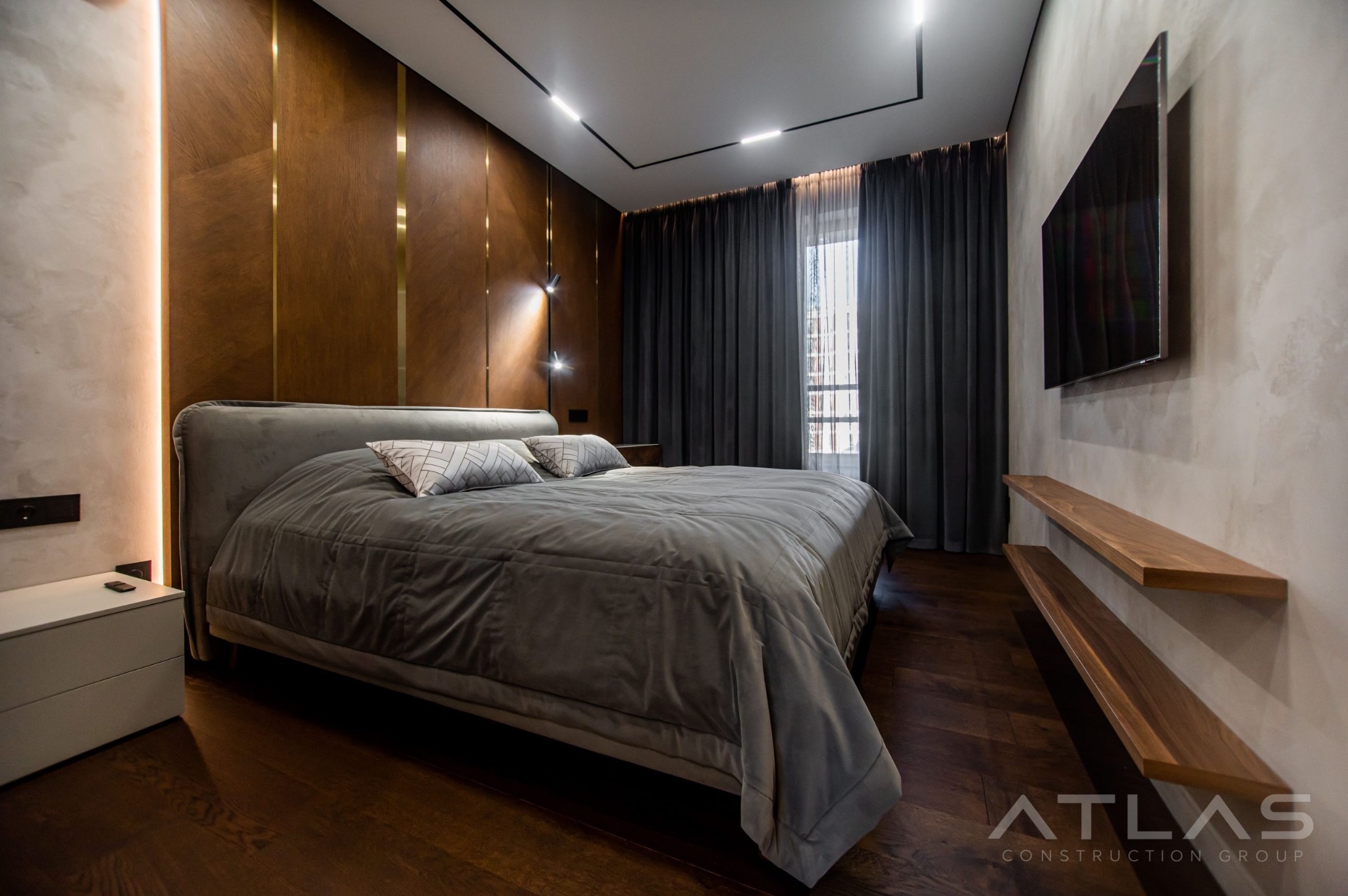 Bedroom with walnut wall panels and integrated lighting