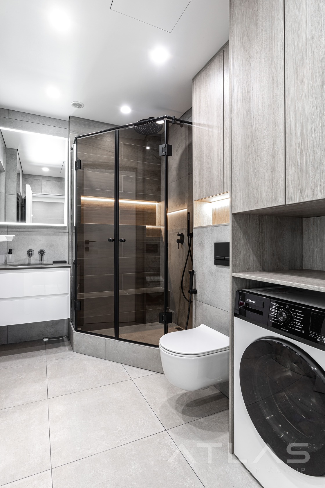 Bathroom with glass shower, gray tile, and LED lighting